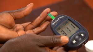 A person checking their blood sugar levels at home